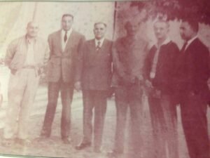 A rare historical photo: His Majesty Mohammad Zahir Shah standing between two major family power blocs. From right to left: Sardar Abdul Wali, Marshal Shah Wali Khan, His Majesty Zahir Shah, Field Marshal Shah Mahmud Khan, Sardar Mohammad Naeem, and Sardar Mohammad Daoud."